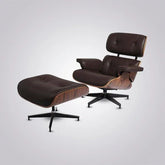 Mid-century modern lounge chair and ottoman with dark leather and wood shell, on black swivel base
